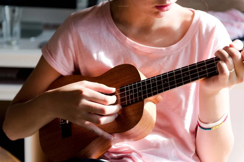 Girl play a guitar 